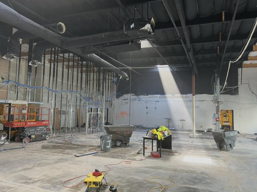 Large open commercial interior with walls and ceiling stripped out